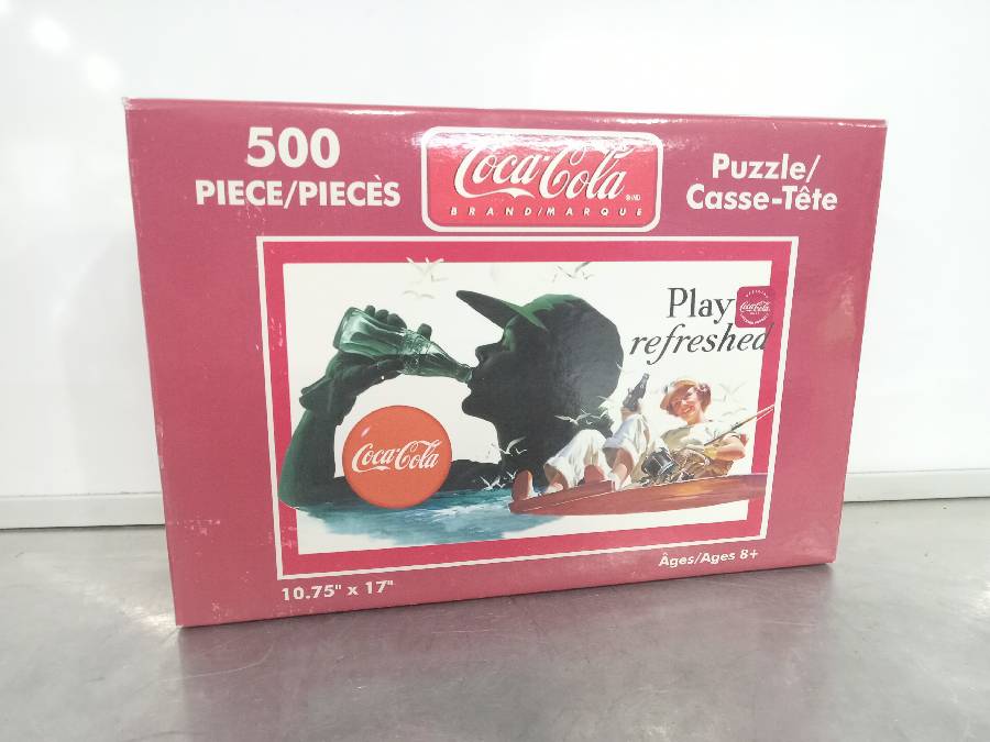 Coca-Cola puzzle in metal container - Northern Kentucky Auction, LLC
